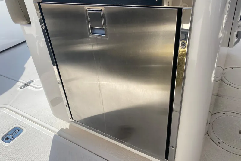 Slide: The Image of Stainless steel door on 2015 Pursuit S 280 Sport boat, reflecting sunlight. - 19