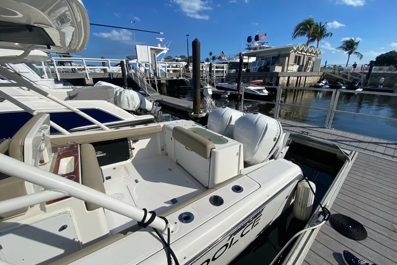 Slide: The Image of 2015 Pursuit S 280 Sport boat docked at marina with clear blue sky. - 2