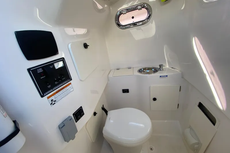 Slide: The Image of 2015 Pursuit S 280 Sport boat interior with toilet and sink. - 21