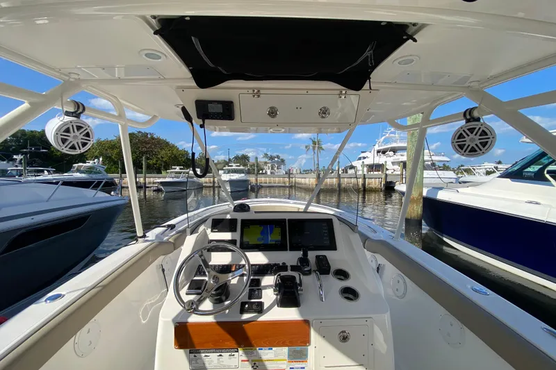 Slide: The Image of 2015 Pursuit S 280 Sport boat cockpit with steering wheel and navigation system. - 3