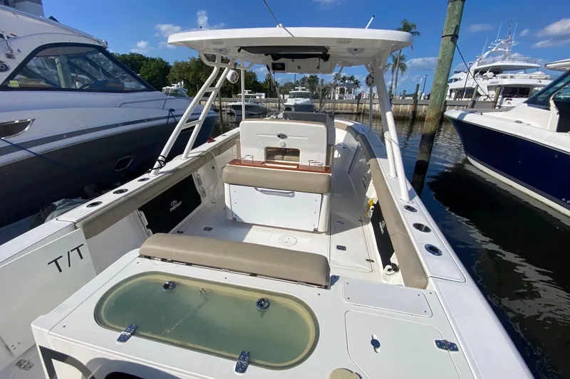 Slide: The Image of 2015 Pursuit S 280 Sport boat docked, featuring spacious seating and modern amenities. - 4