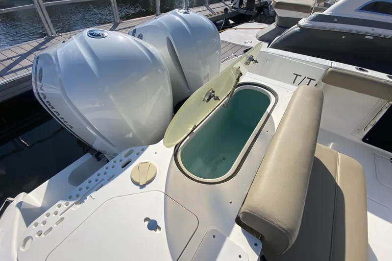 Slide: The Image of 2015 Pursuit S 280 Sport boat with dual Yamaha engines and open storage compartment. - 5