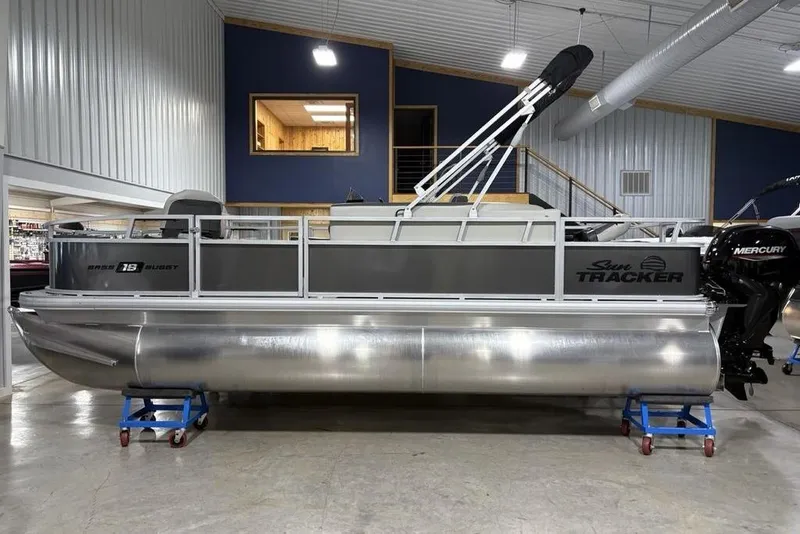 The Image of 2026 Sun Tracker Bass Buggy 18 DLX pontoon boat displayed indoors. - 1