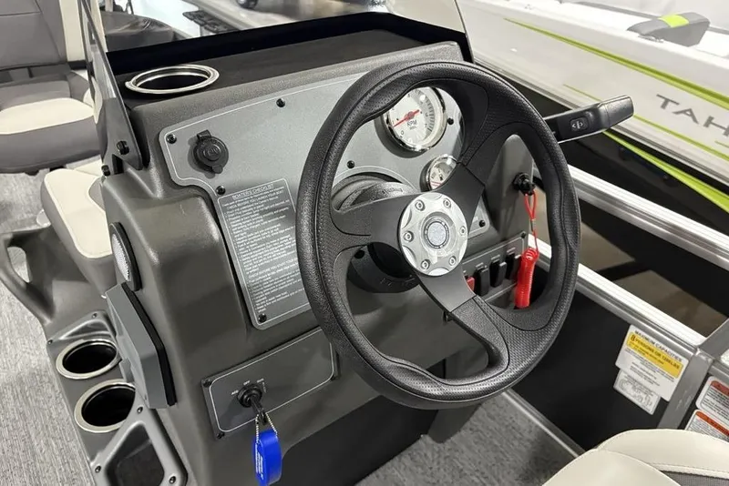 Slide: The Image of 2026 Sun Tracker Bass Buggy 18 DLX steering console with gauges and controls. - 12