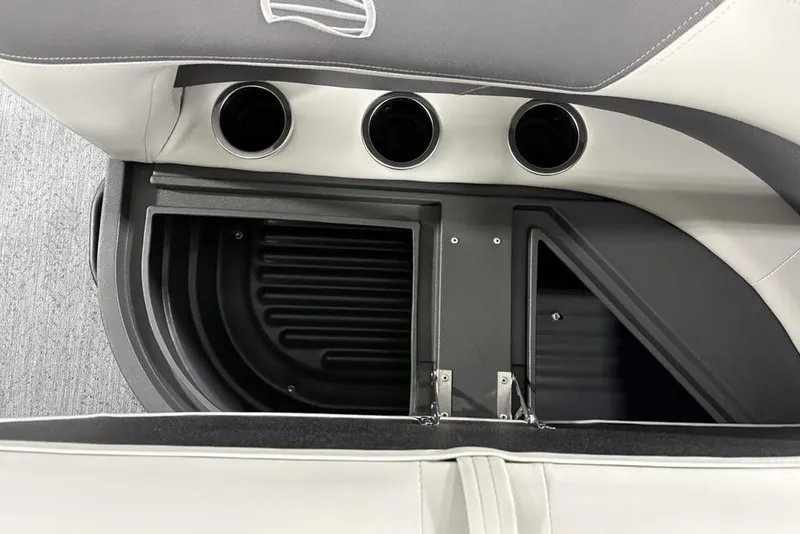 Slide: The Image of 2026 Sun Tracker Bass Buggy 18 DLX interior storage compartment with cup holders. - 15