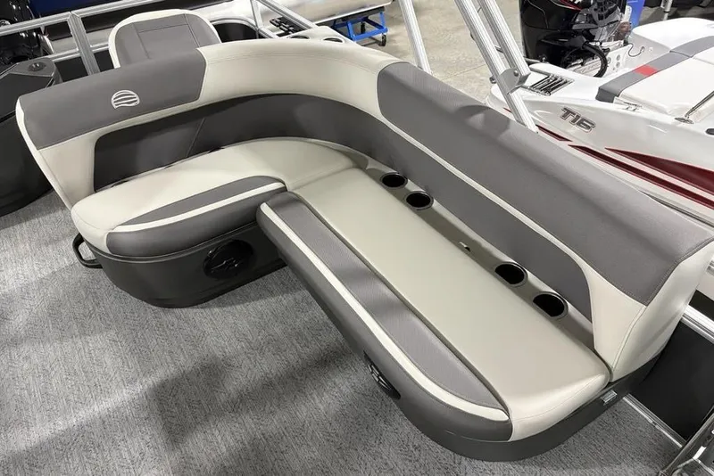 Slide: The Image of 2026 Sun Tracker Bass Buggy 18 DLX boat seating with cup holders, gray and beige upholstery. - 17