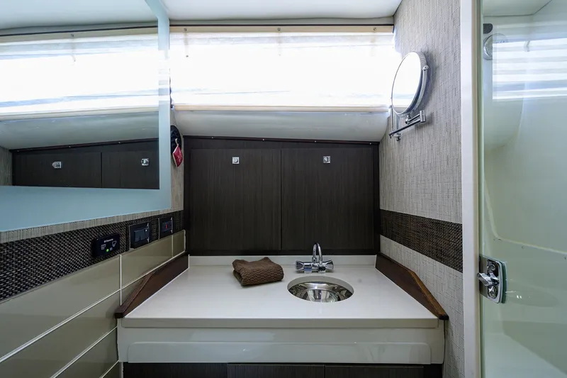 Slide: The Image of 1965 Bertram 38 Sport Fisherman bathroom with modern sink and mirror. - 41
