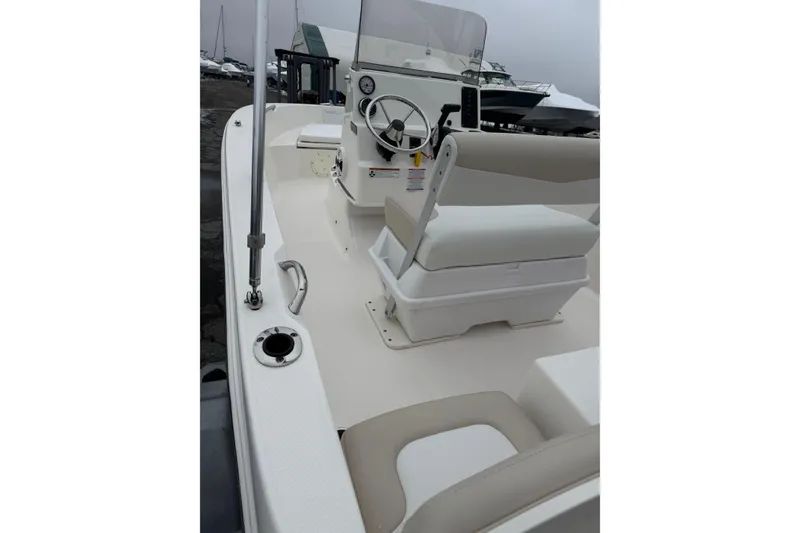 Slide: The Image of 2021 Robalo R160 Center Console boat interior with steering wheel and seating. - 10