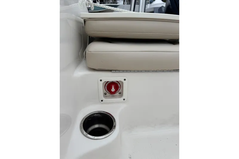 Slide: The Image of 2021 Robalo R160 Center Console boat interior with beige seating and cup holder. - 11