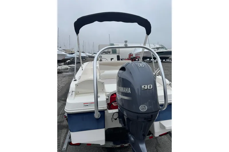 Slide: The Image of 2021 Robalo R160 Center Console boat with Yamaha 90 engine, docked outdoors. - 13