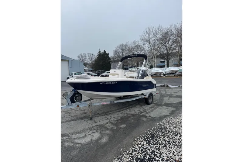 Slide: The Image of 2021 Robalo R160 Center Console boat on trailer in a marina setting. - 5