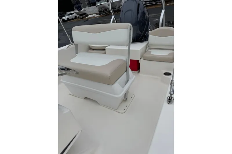 Slide: The Image of 2021 Robalo R160 Center Console boat interior with seating and storage. - 8