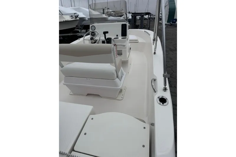 Slide: The Image of 2021 Robalo R160 Center Console boat interior with steering wheel and seating. - 9