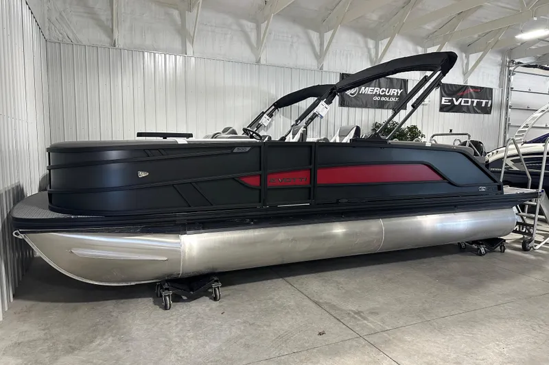 Slide: The Image of 2026 Evotti 521QL pontoon boat in showroom, sleek black and red design. - 1