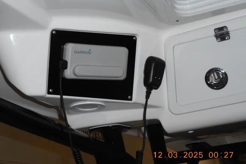 Slide: The Image of 2023 Sea Fox 288 Commander dashboard with Garmin device and microphone. - 28