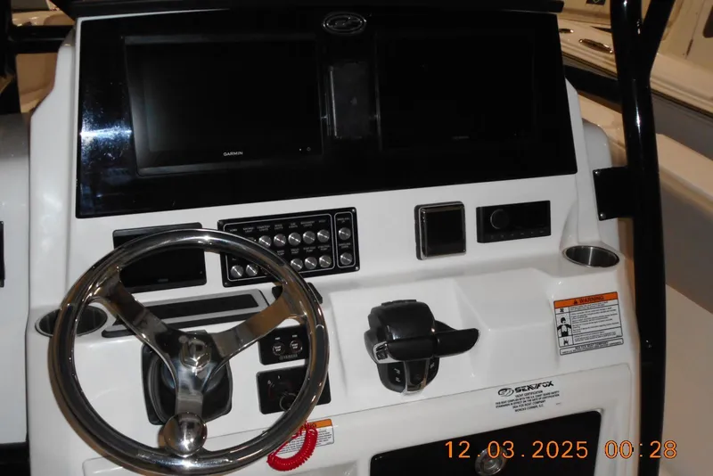 Slide: The Image of 2023 Sea Fox 288 Commander dashboard with steering wheel and control panel. - 29