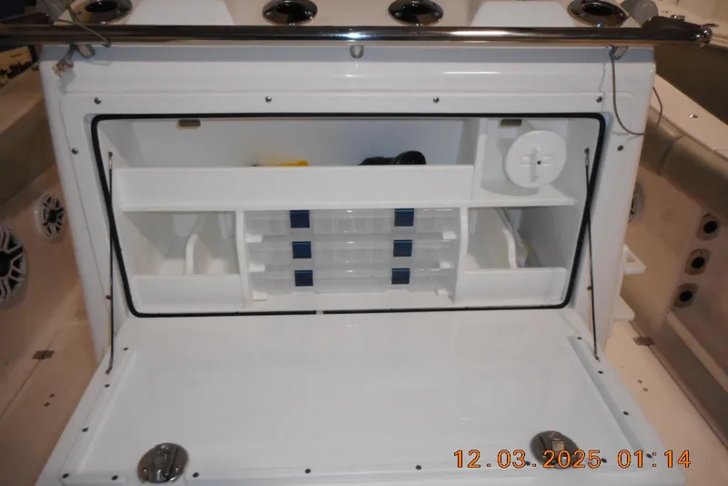 Slide: The Image of 2023 Sea Fox 288 Commander boat storage compartment with organized shelves and tackle boxes. - 39