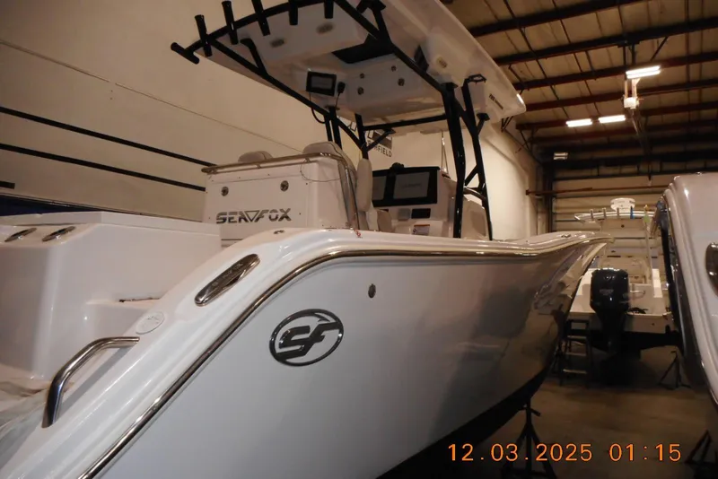 Slide: The Image of 2023 Sea Fox 288 Commander boat in showroom, side view with visible console and equipment. - 44