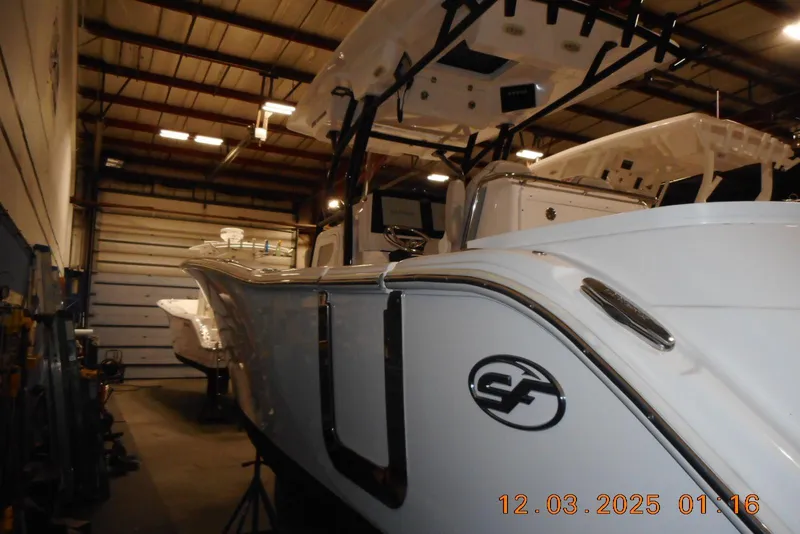 Slide: The Image of 2023 Sea Fox 288 Commander boat in a warehouse, side view with logo visible. - 45
