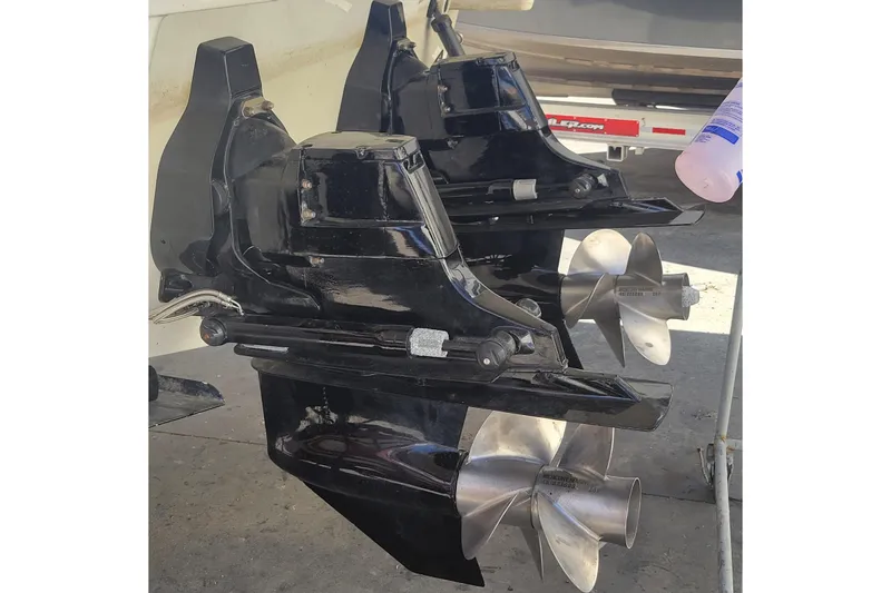 Slide: The Image of 2006 Formula 330 Sun Sport boat propellers and outdrives in a maintenance setting. - 28