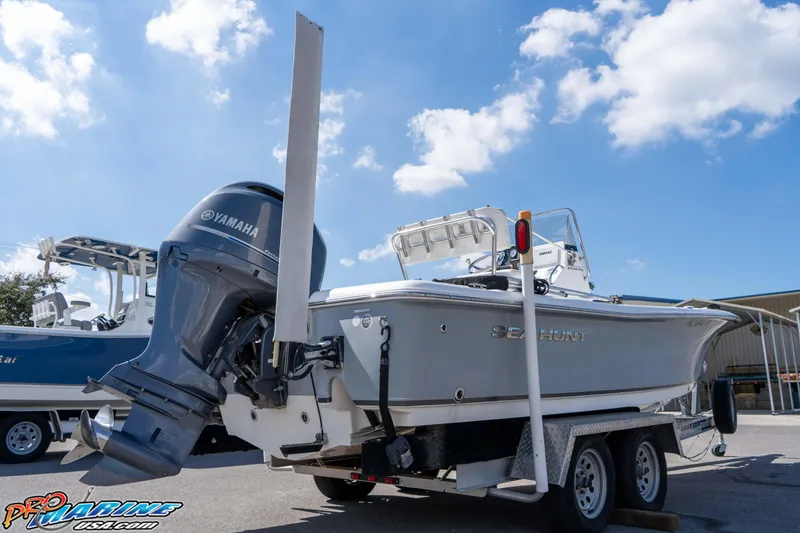Slide: The Image of 2014 Sea Hunt BX 22 Pro boat on trailer with Yamaha outboard motor under blue sky. - 12