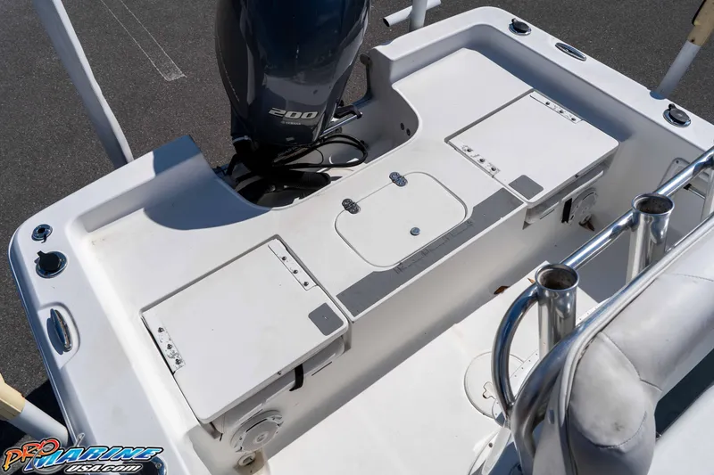 Slide: The Image of 2014 Sea Hunt BX 22 Pro boat deck with Yamaha 200 engine, featuring storage compartments. - 14