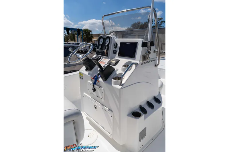 Slide: The Image of 2014 Sea Hunt BX 22 Pro boat console with steering wheel and gauges. - 17