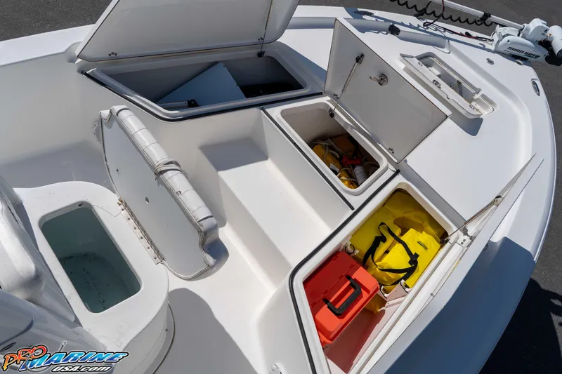 Slide: The Image of 2014 Sea Hunt BX 22 Pro boat storage compartments with safety gear and equipment. - 21