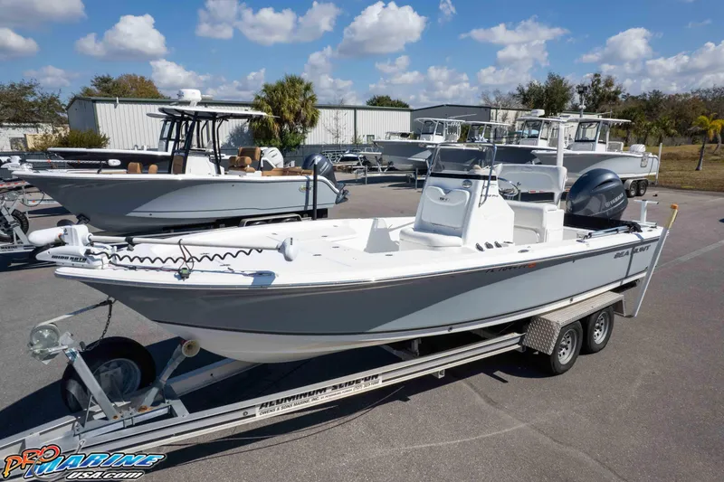 Slide: The Image of 2014 Sea Hunt BX 22 Pro boat on trailer, parked outdoors under a blue sky. - 24