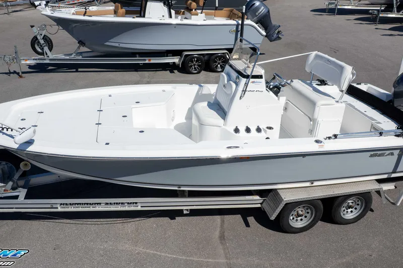 Slide: The Image of 2014 Sea Hunt BX 22 Pro boat on trailer, parked in a marina. - 26