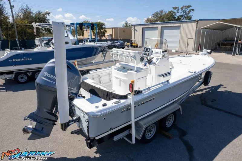 Slide: The Image of 2014 Sea Hunt BX 22 Pro boat on trailer with Yamaha engine in marina setting. - 33