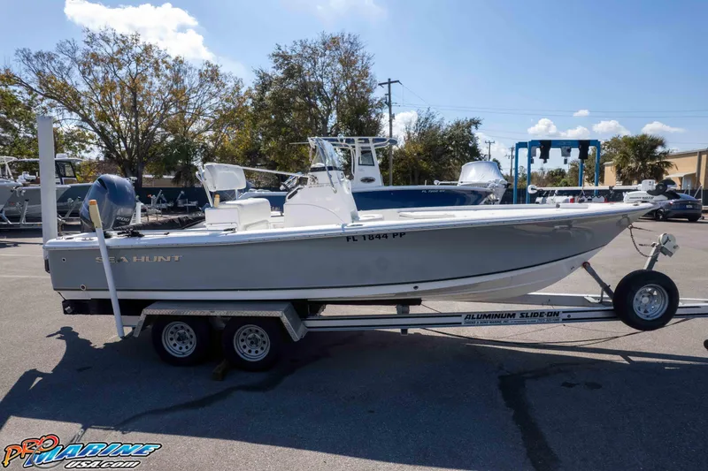 Slide: The Image of 2014 Sea Hunt BX 22 Pro boat on trailer, parked outdoors under clear sky. - 35