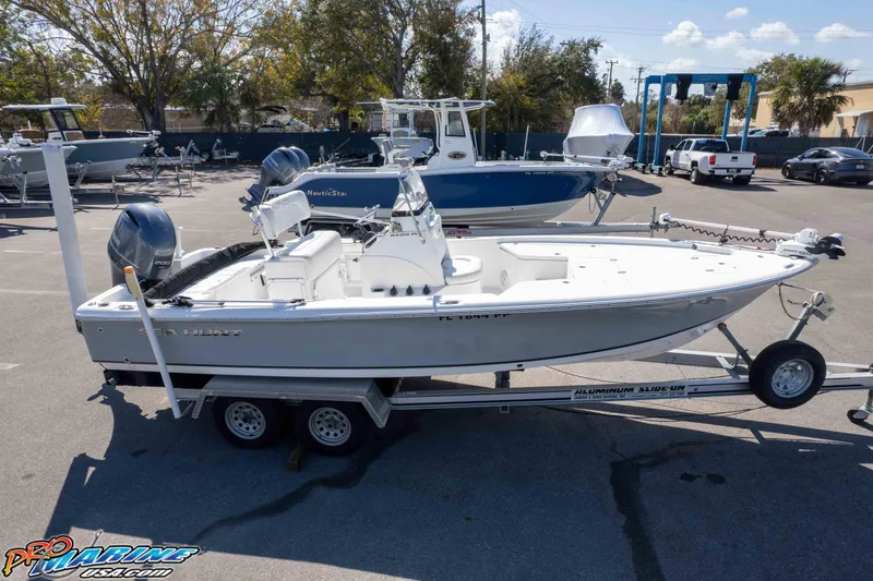 Slide: The Image of 2014 Sea Hunt BX 22 Pro boat on trailer in marina parking lot. - 36