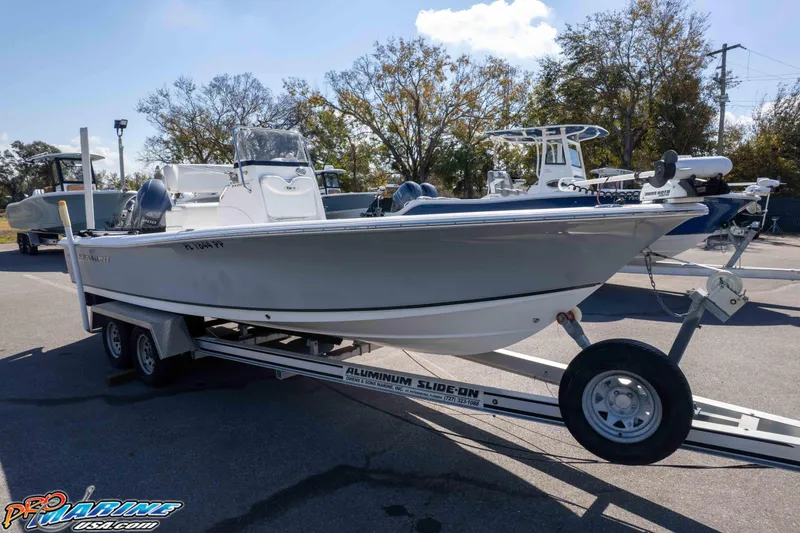 Slide: The Image of 2014 Sea Hunt BX 22 Pro boat on trailer, parked outdoors under clear sky. - 37