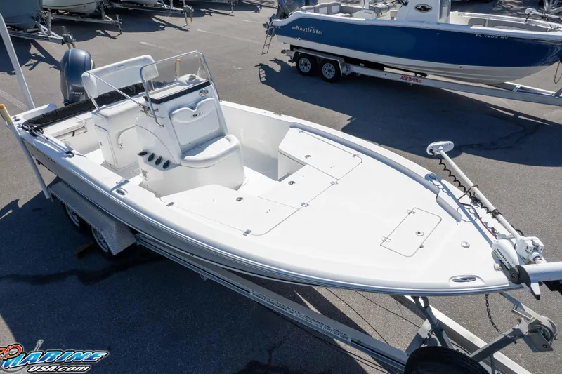 Slide: The Image of 2014 Sea Hunt BX 22 Pro boat on trailer, white exterior, parked outdoors. - 39