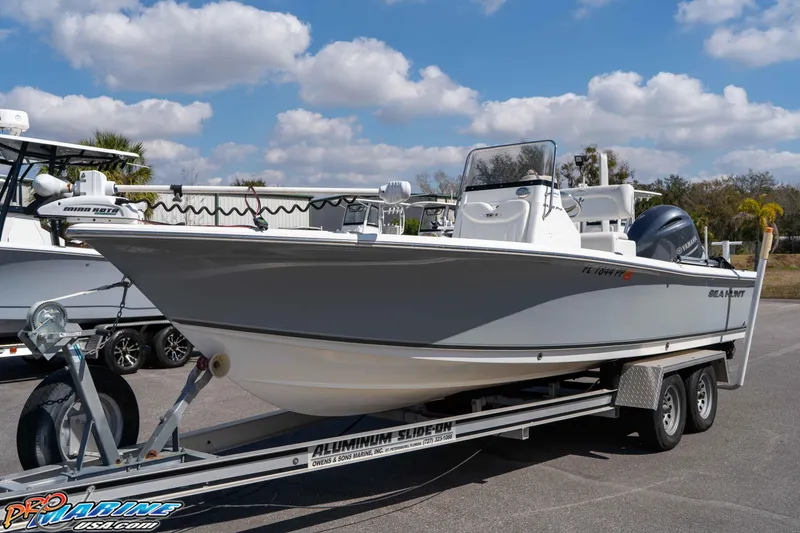 Slide: The Image of 2014 Sea Hunt BX 22 Pro boat on trailer under blue sky. - 6