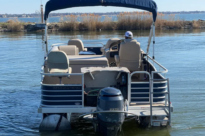 Slide: The Image of 2012 Bennington 2275 GFS pontoon boat on calm lake waters. - 6