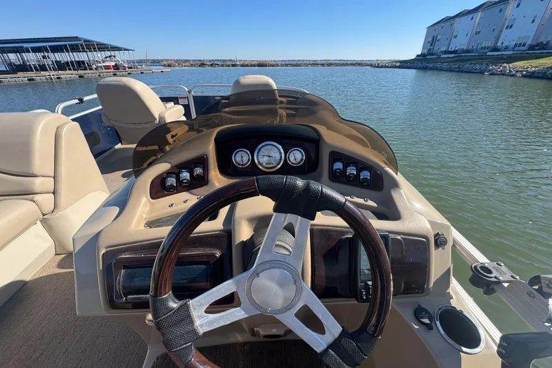 Slide: The Image of Steering console of a 2012 Bennington 2275 GFS boat on a calm lake. - 7