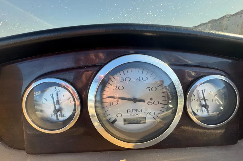 Slide: The Image of Dashboard of a 2012 Bennington 2275 GFS boat showing fuel, RPM, and trim gauges. - 8