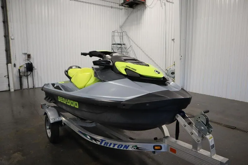 Slide: The Image of 2021 Sea-Doo GTI SE 170 jet ski on trailer in indoor setting. - 3