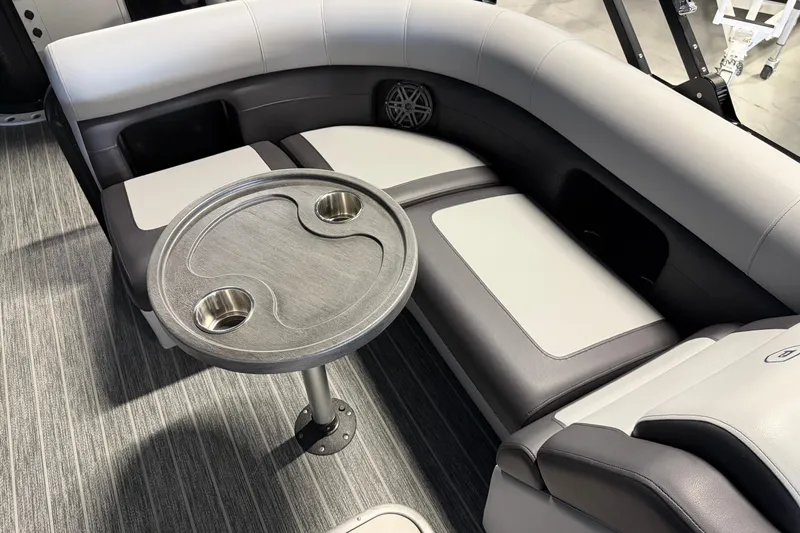 Slide: The Image of Luxurious seating area on 2025 Premier 230 Sunsation Angler 2pt boat with table and cup holders. - 13