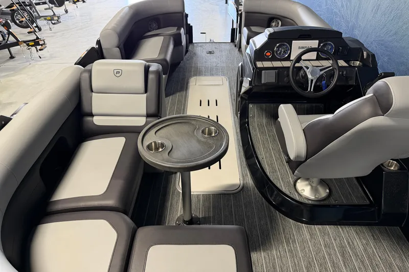 Slide: The Image of 2025 Premier 230 Sunsation Angler 2pt interior with seating, table, and helm. - 14