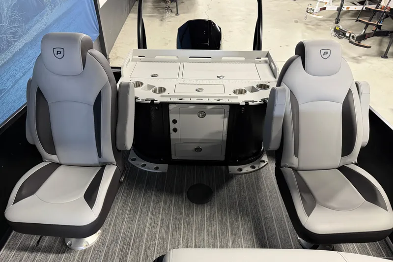 Slide: The Image of 2025 Premier 230 Sunsation Angler 2pt boat interior with two gray seats and storage console. - 15