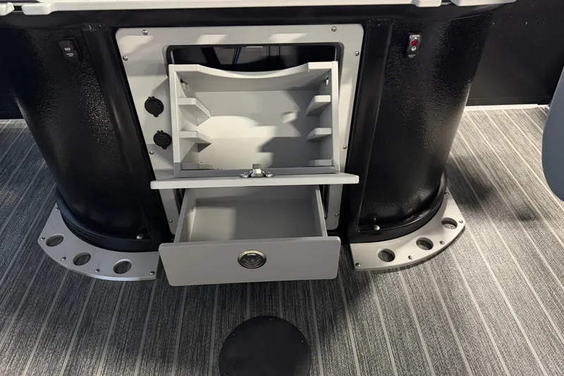 Slide: The Image of 2025 Premier 230 Sunsation Angler 2pt boat storage compartment with open drawers. - 16