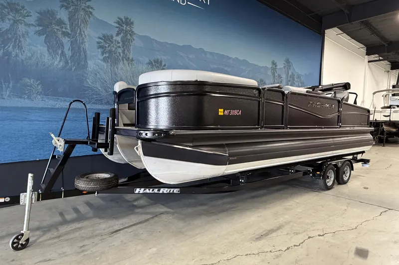 Slide: The Image of 2025 Premier 230 Sunsation Angler 2pt pontoon boat on trailer in showroom. - 2