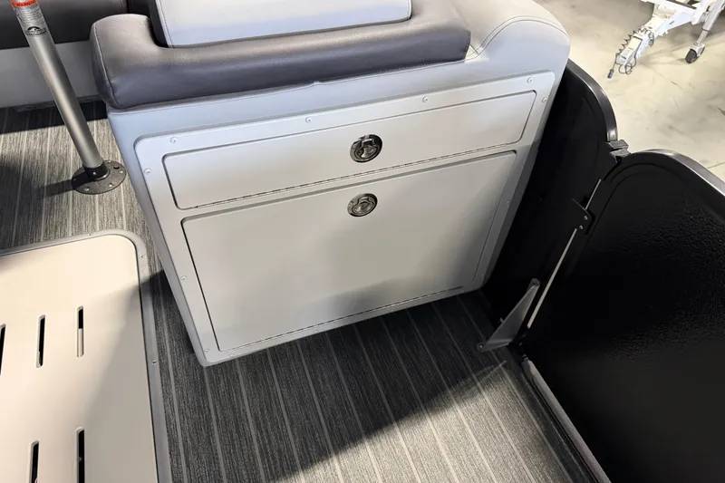Slide: The Image of Interior of 2025 Premier 230 Sunsation Angler 2pt boat with storage compartment and seating. - 21
