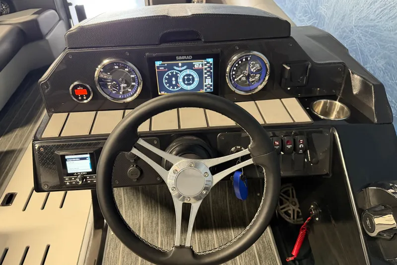 Slide: The Image of 2025 Premier 230 Sunsation Angler 2pt dashboard with steering wheel and digital display. - 9