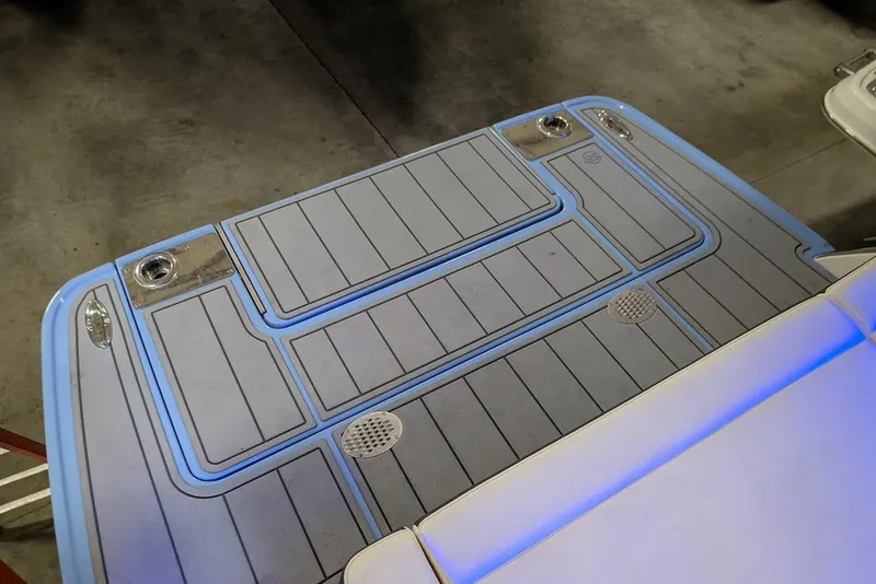 Slide: The Image of 2024 Chaparral 267 SSX swim platform with blue LED lighting and textured surface. - 10