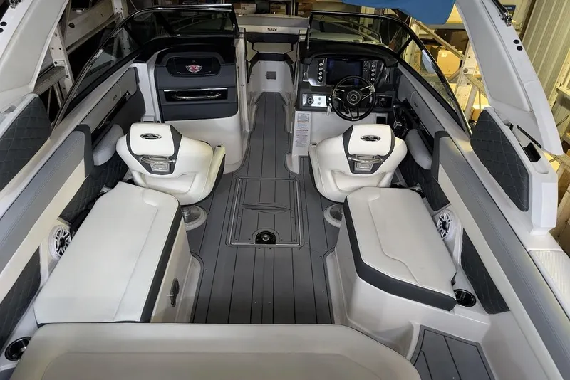 Slide: The Image of 2024 Chaparral 267 SSX boat interior with luxurious seating and modern dashboard. - 15
