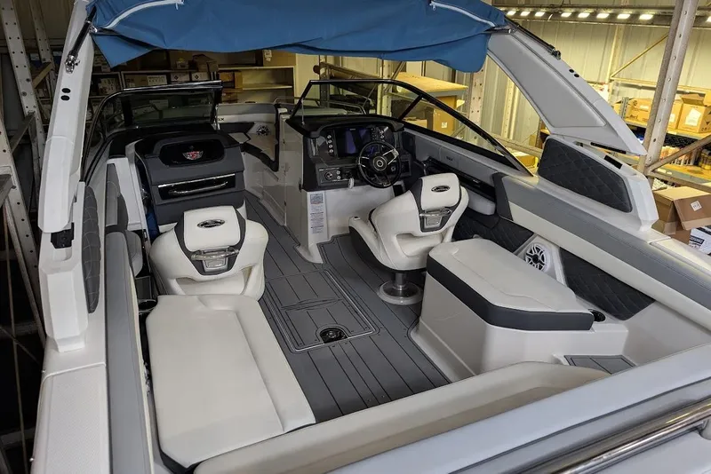 Slide: The Image of 2024 Chaparral 267 SSX boat interior with modern seating and dashboard design. - 16